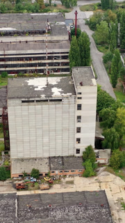 Exterior of industrial destroyed buildings. Destroyed aerial view of huge territory factory. Vertical video