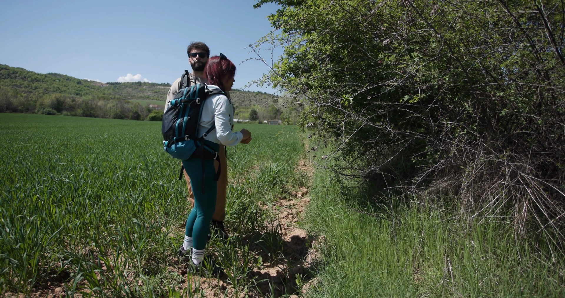 A Couple Hikes Through Green Field Exploring Stock Footage SBV ...