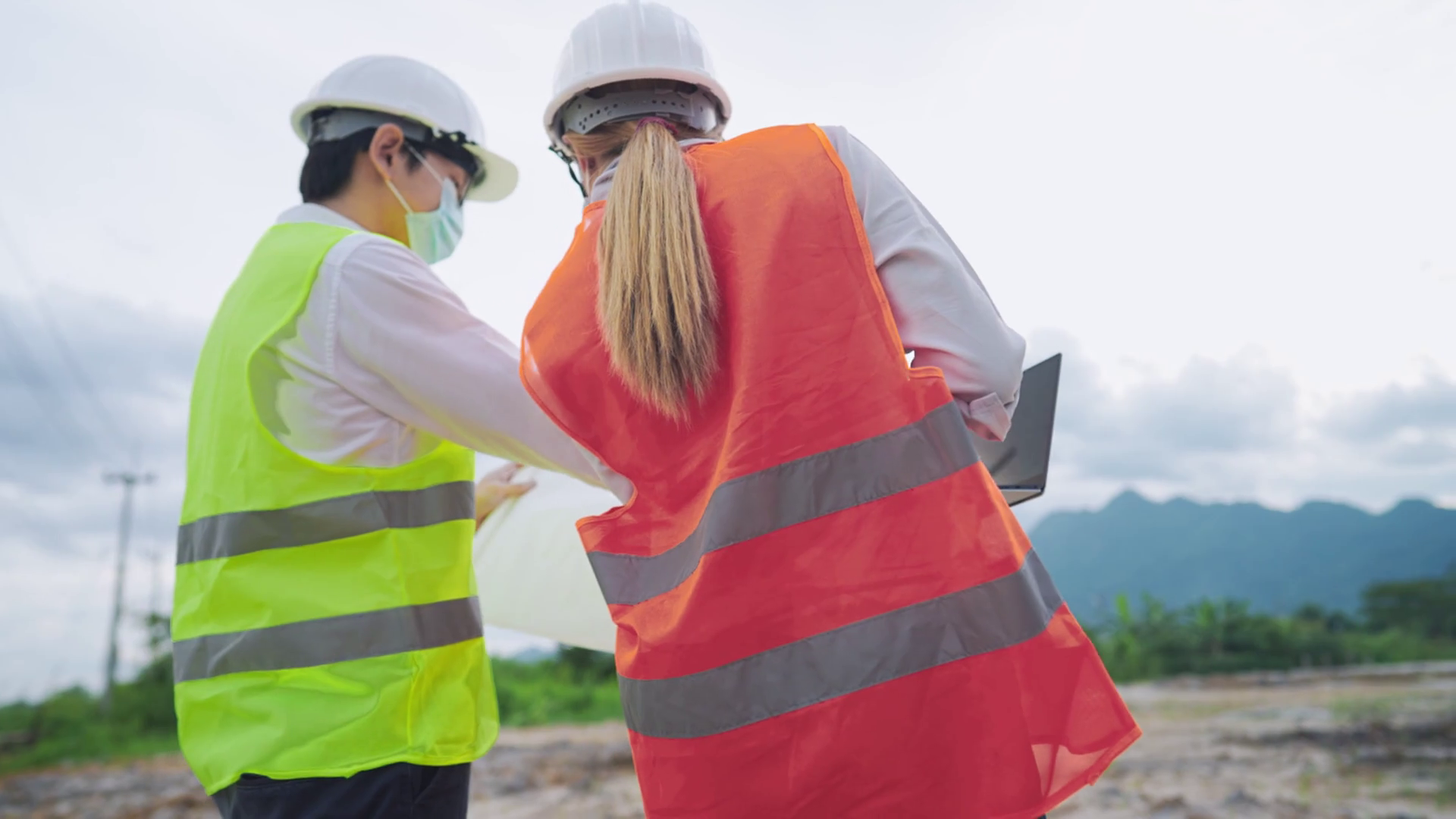 Safety first, two civil engineer workers wear fluorescent safety vest