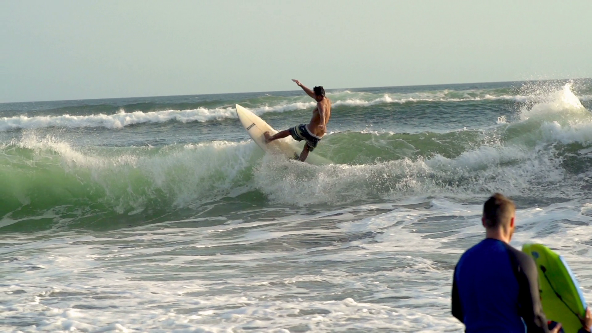 Surfer surfing on the waves in the sea, steadycam shot, slow motion shot at 240f Stock Video
