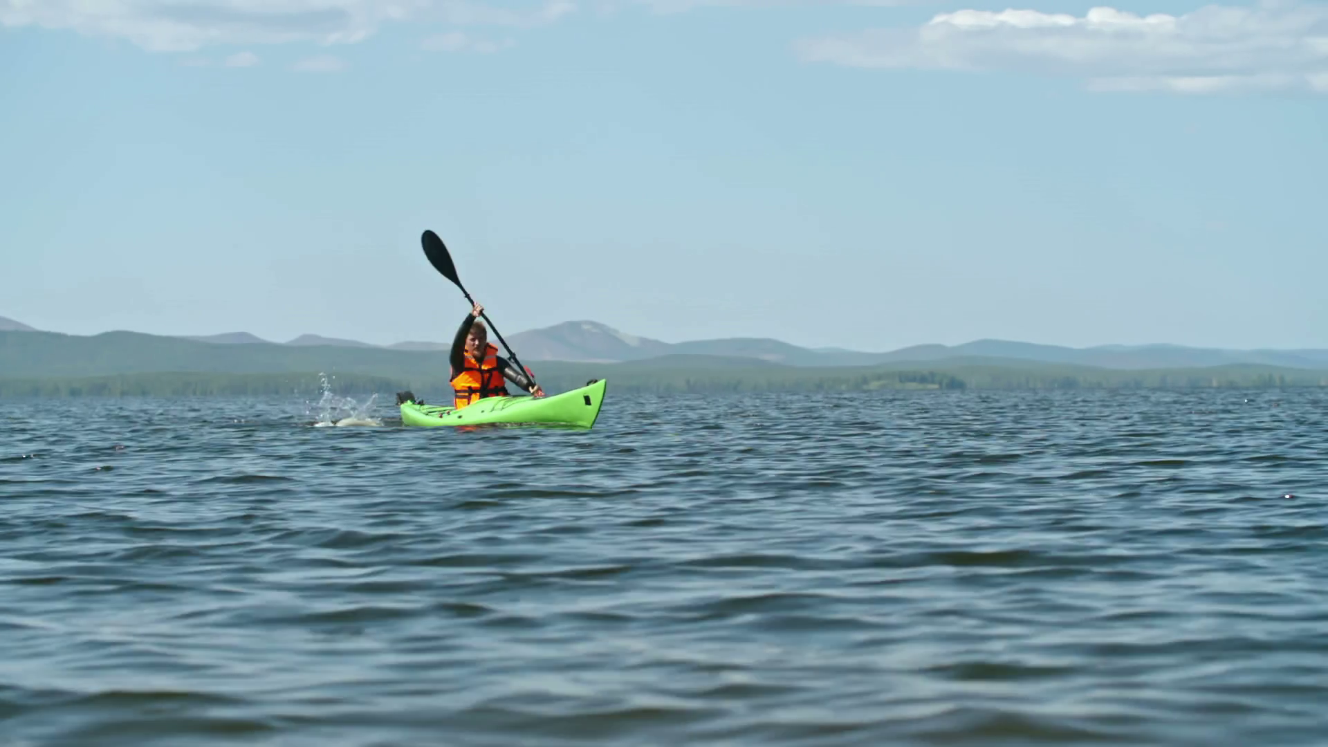Lockdown of male amateur water sports athlete practicing forward sweeping on his kayak Stock