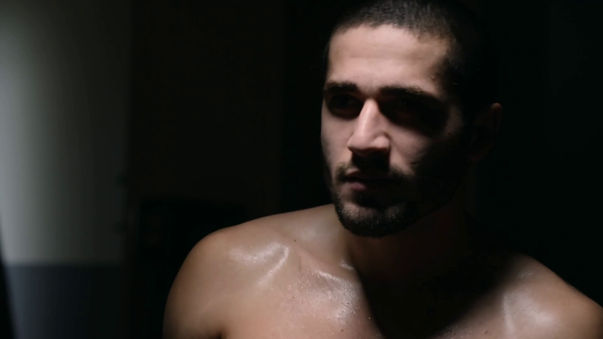 Professional MMA fighter throwing punches in the air while boxing in