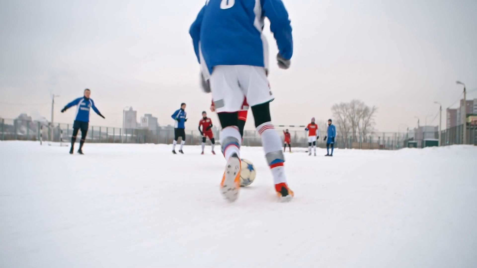 Soccer player handling a ball, getting around opposing players and