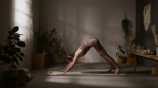 Wide timelapse of young Caucasian girl entering exercise room, rolling out mat, performing sun salutation sequence with upward and downward dog asanas, lying in shavasana, getting up and leaving