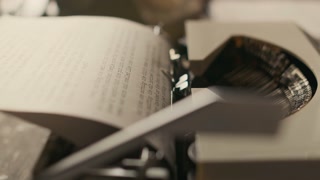 No people close up shot of vintage typewriter typing text on loaded paper