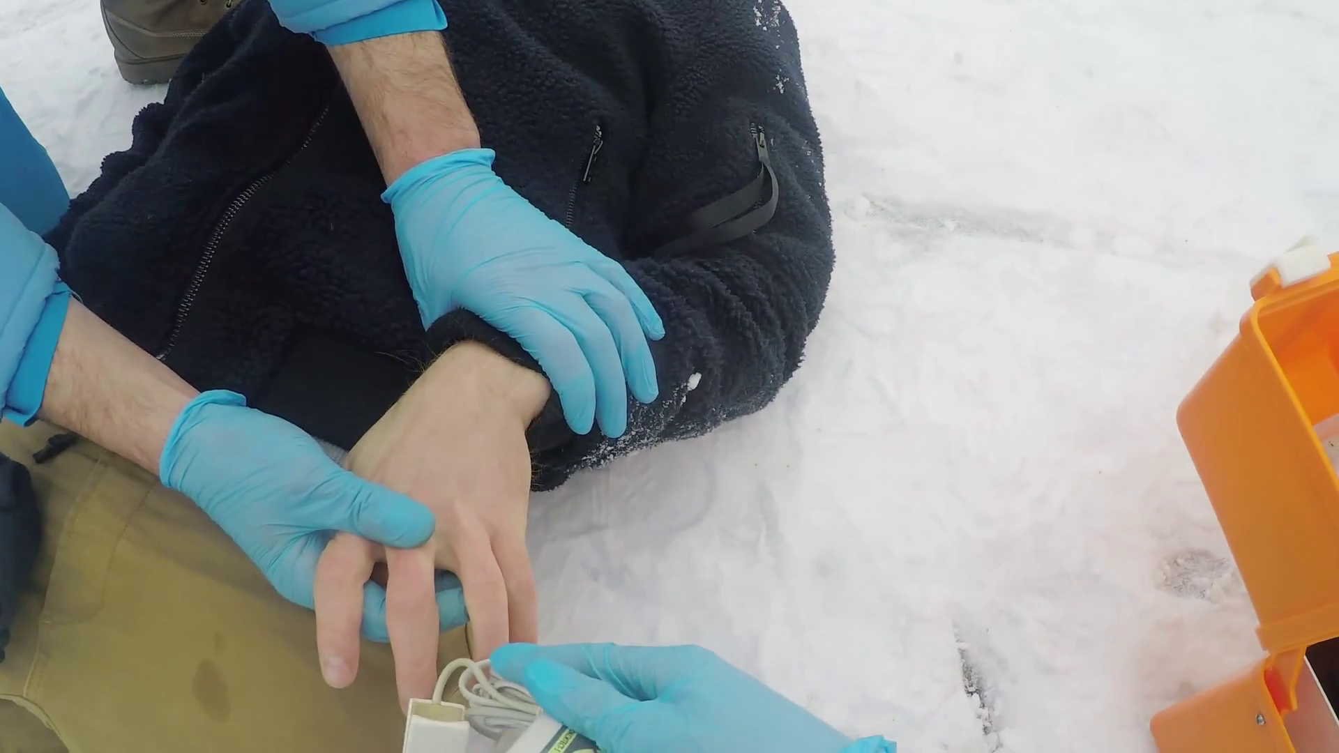 Action camera shot with POV of paramedic using pulse oximeter and