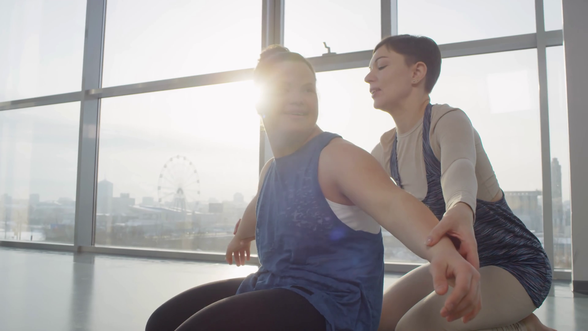 Cheerful disabled woman with down syndrome working on her body doing