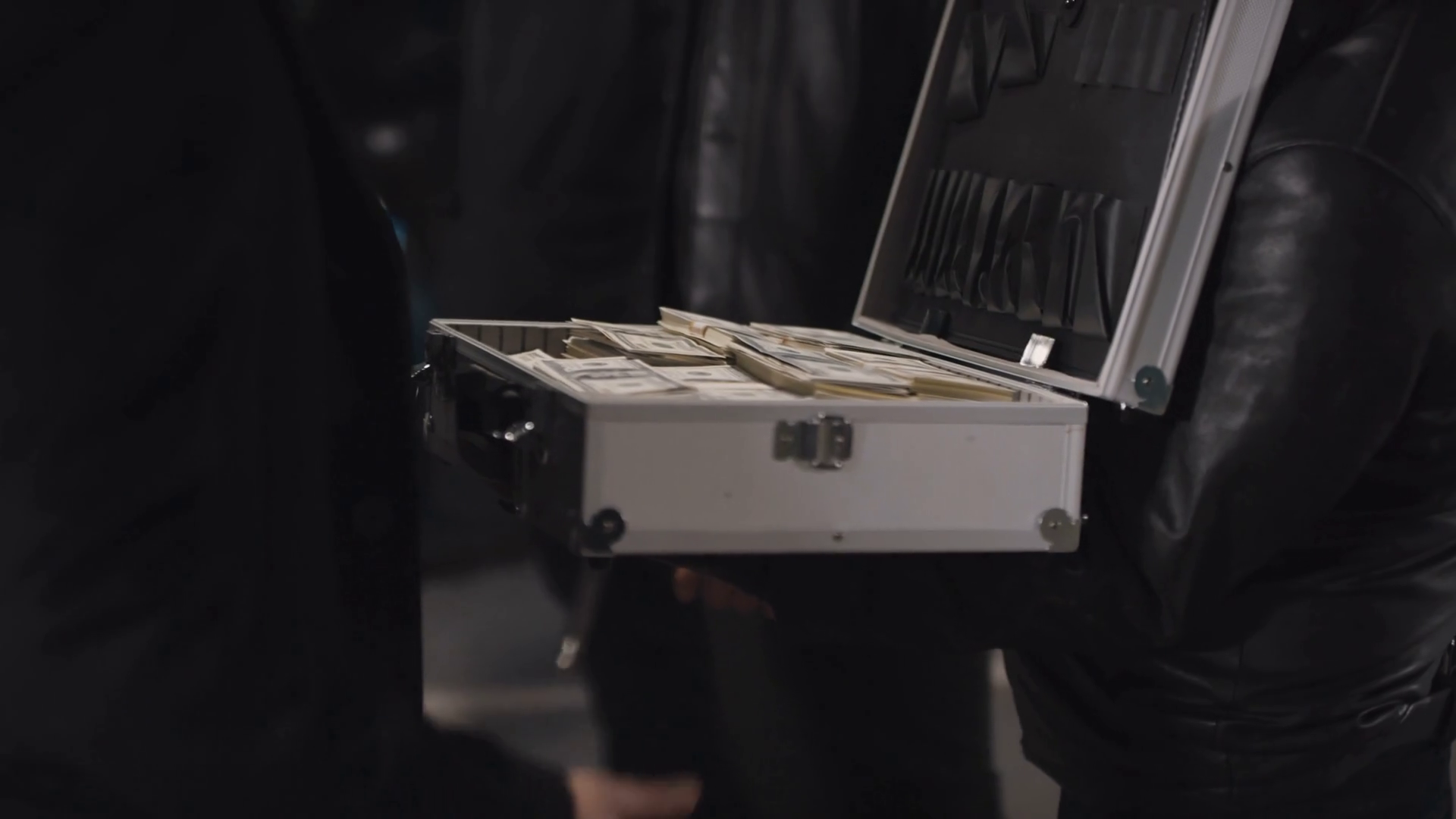 Closeup of unrecognizable male hands of criminal taking briefcase with ...
