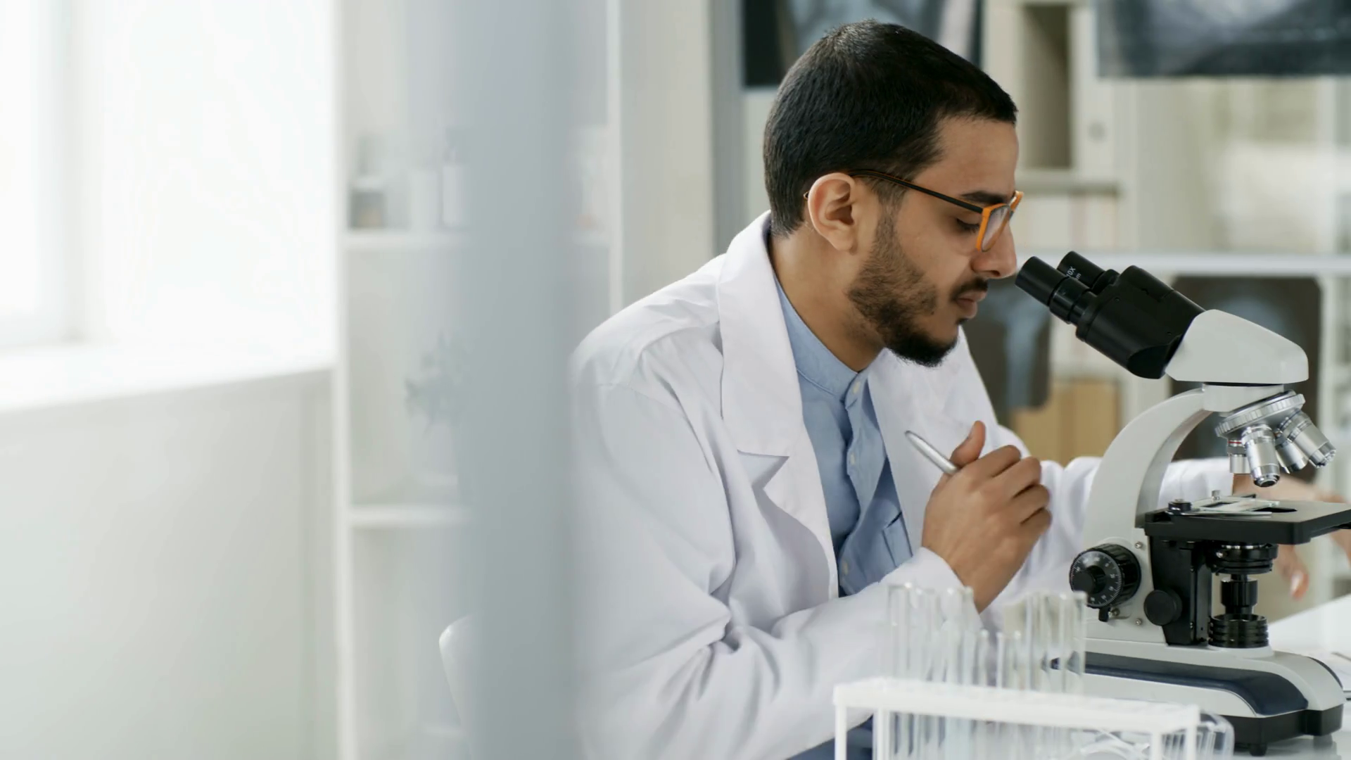 Tracking Shot Of Young Man In Lab Coat Using Stock Footage SBV ...