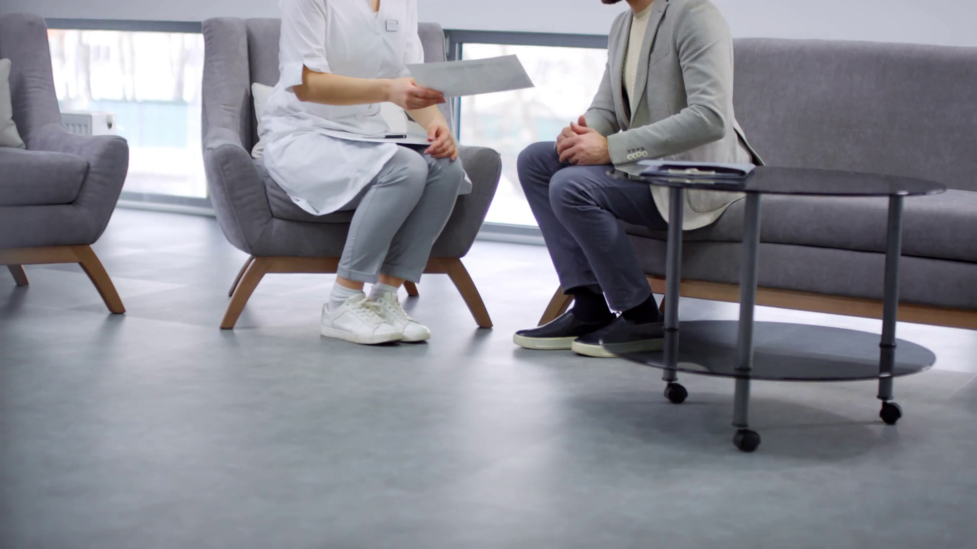 Sequence of female doctor in white coat sitting on armchair in