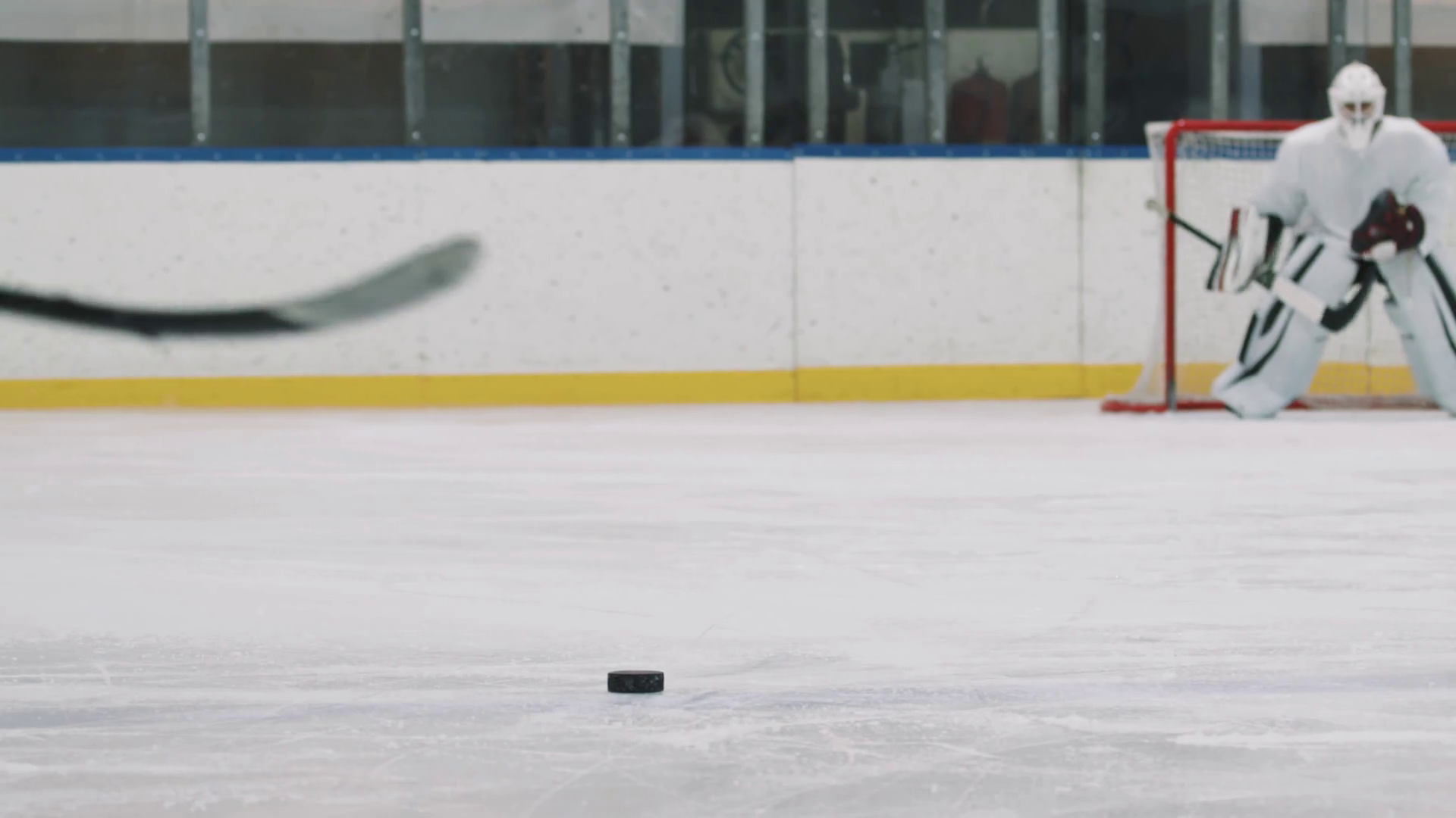 Lowangle rearview PAN with slowmo of male hockey players trying to