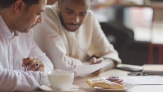 Business Meeting: Young Black Muslim Man and Middle Eastern Partner Discussing Work