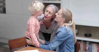 Grandchild giving Grandmother a kiss goodbye