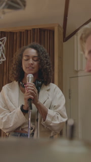 Female Singer with Drummer Playing Live in Music Studio