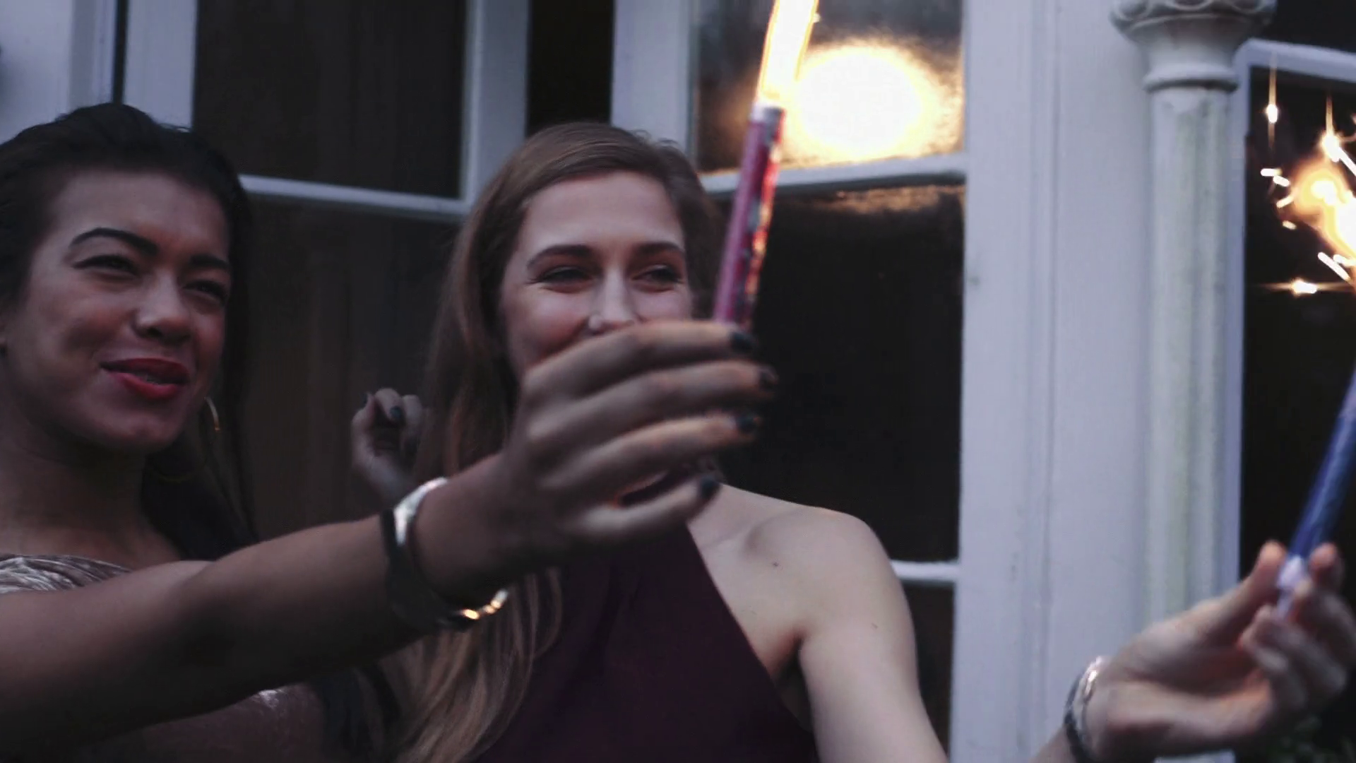 Young women playing with fire crackers during Christmas Stock Video