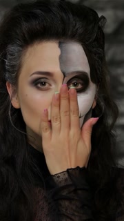 Enchanting woman blowing a kiss with striking skeleton makeup