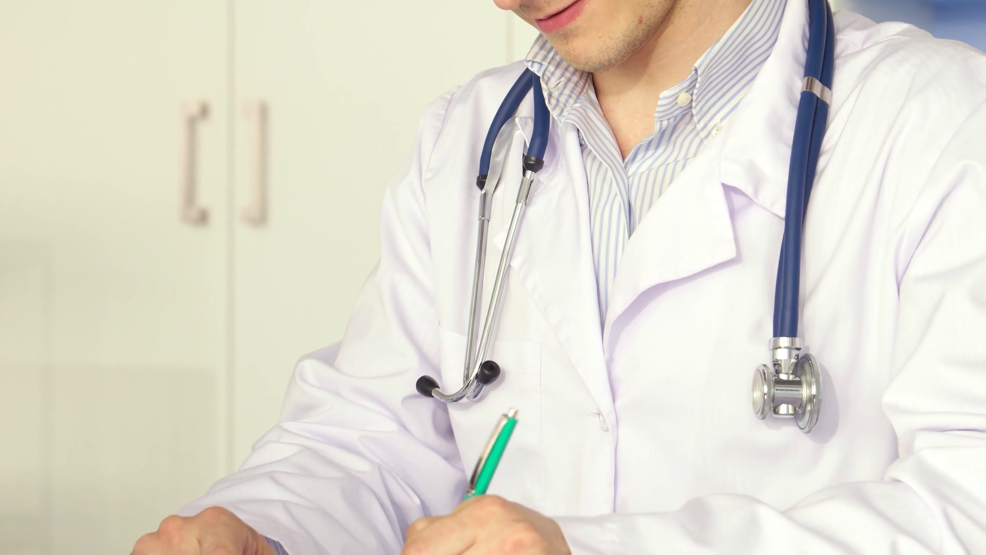 Dedicated Male Doctor Diligently Noting Stock Footage SBV-352092957 ...