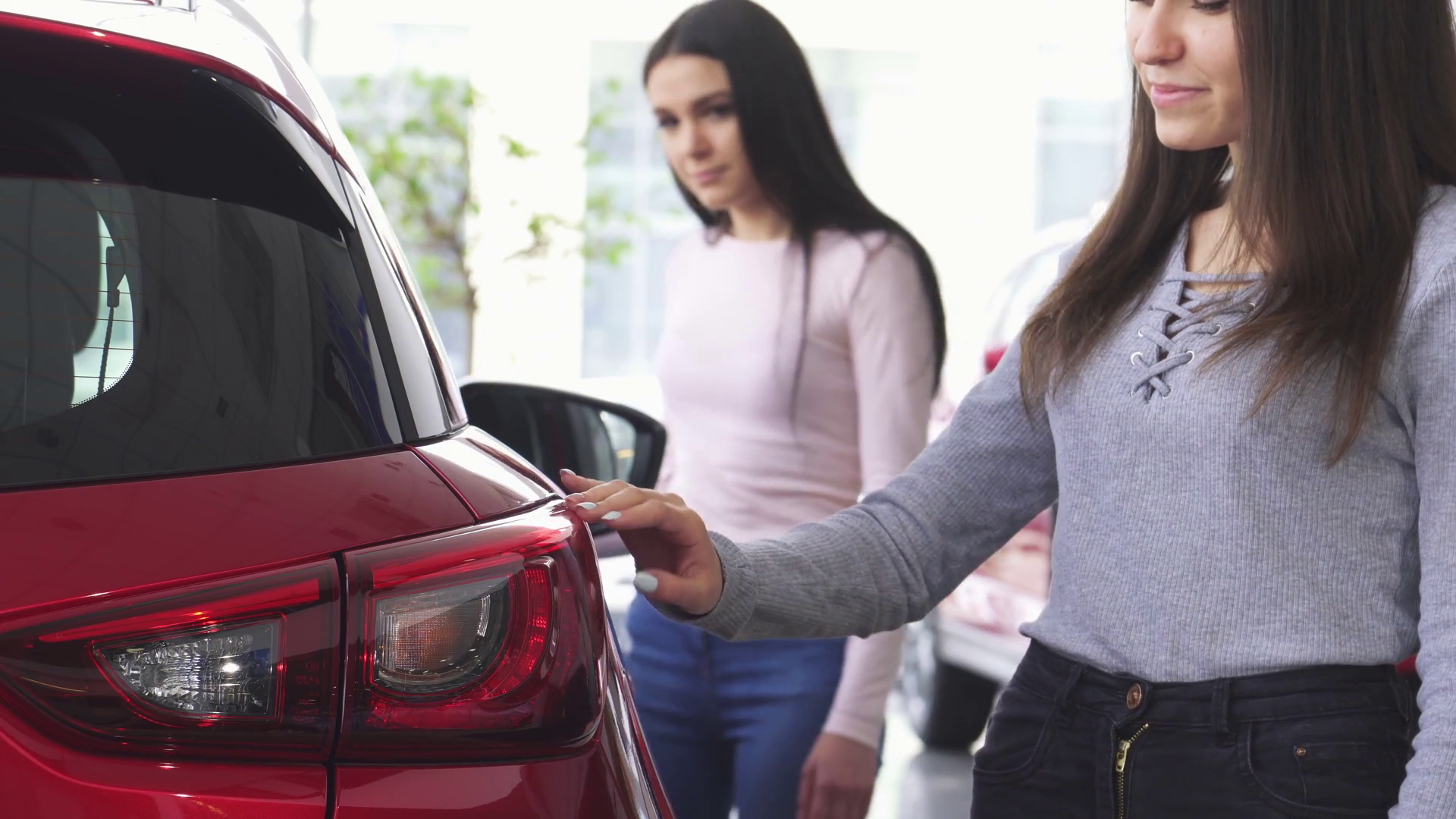Two Women Exploring Cars At Dealership Stock Footage SBV-352183008 ...