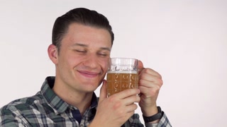 Happy man enjoying a warm beverage