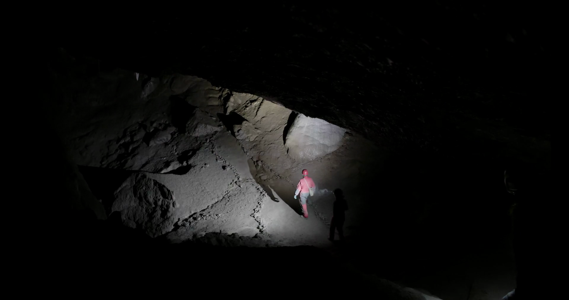 Going Underground Into Cave With Flashlights Stock Footage SBV