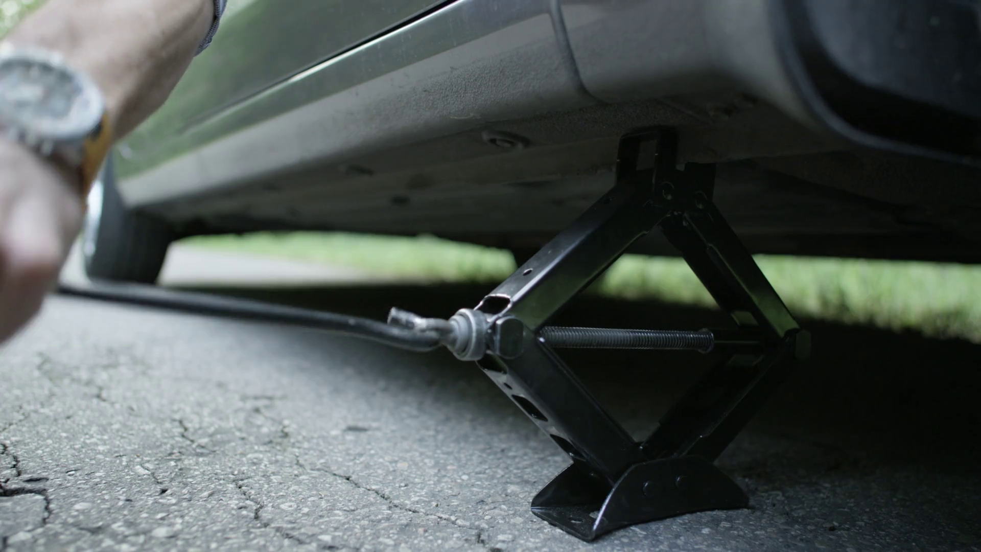 Hands Of Man Lowering Car With Jack Stock Footage SBV317402460