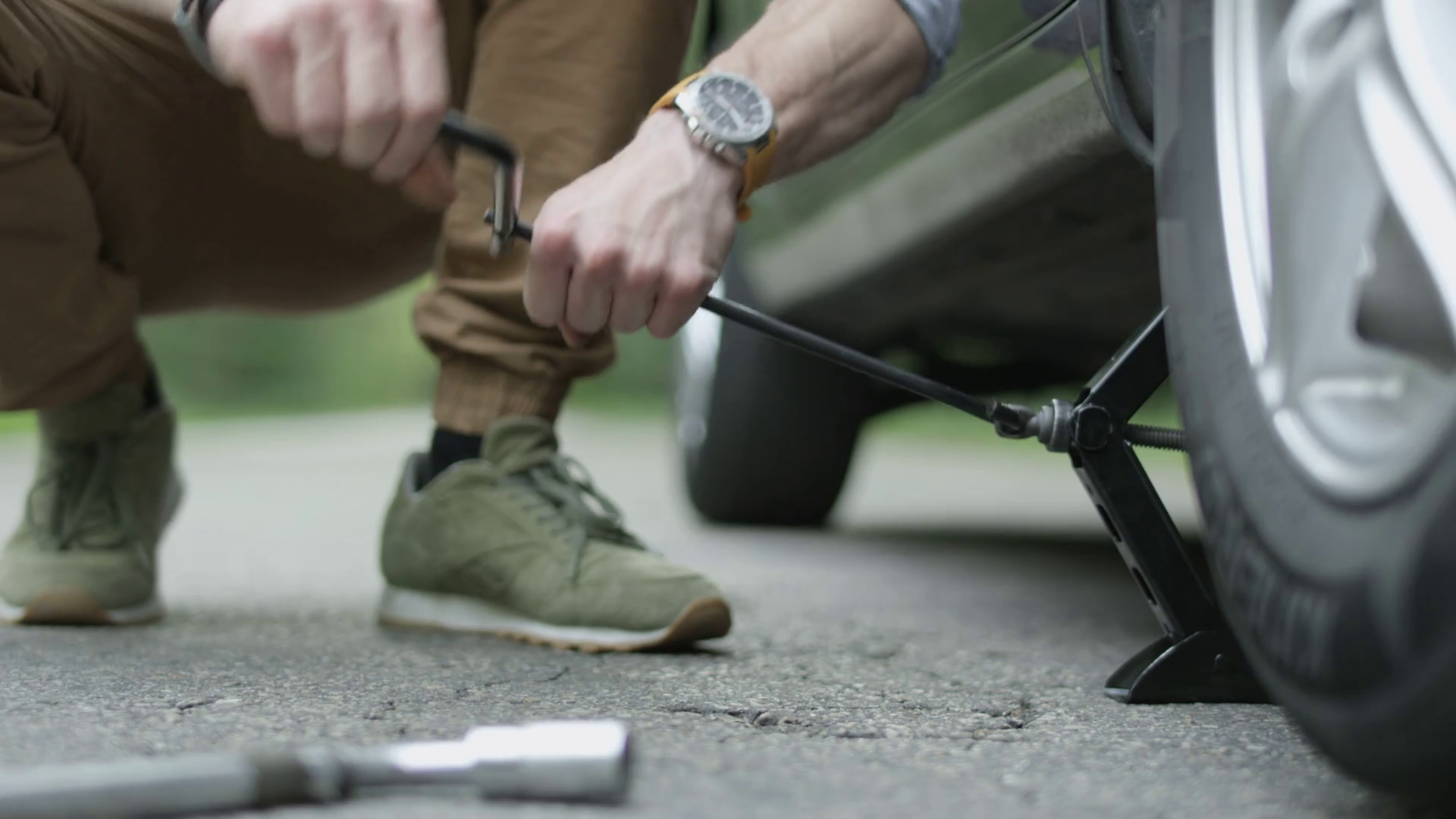 Hands Of Man Lowering Car With Jack Stock Footage SBV317299101