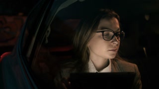 Woman Using a Tablet Computer and Turning to the Right