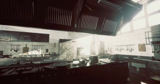 Abandoned commercial kitchen filled with sunlight and worn equipment