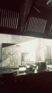 Abandoned commercial kitchen filled with sunlight and worn equipment