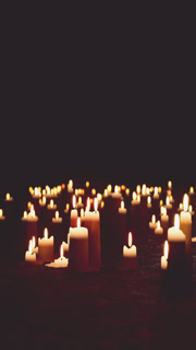 Many Lit Candles in Darkness