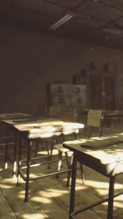 Old classroom with empty desks and sunlight shining through windows