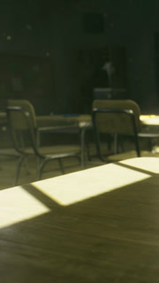 Empty classroom with sunlight shining on a wooden table in the afternoon