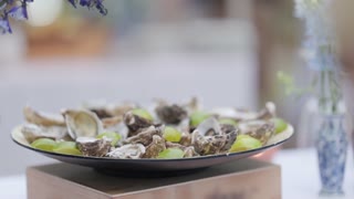 Rotating plate of oysters and lime wedges at a celebration