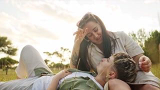 Woman making i love you sign language to her girlfriend