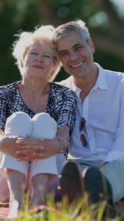 Happy senior couple enjoying a relaxing picnic in the park