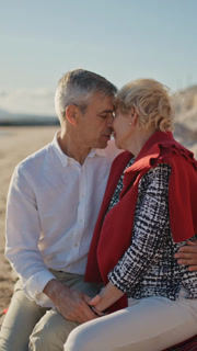 Senior couple sharing intimate moments on beach