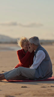 Elderly couple enjoying a romantic sunset on the beach