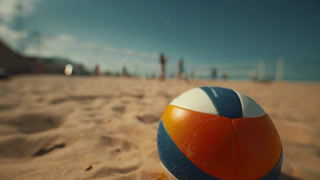 Beach volleyball game takes place on sandy court during sunny day with players competing in the background
