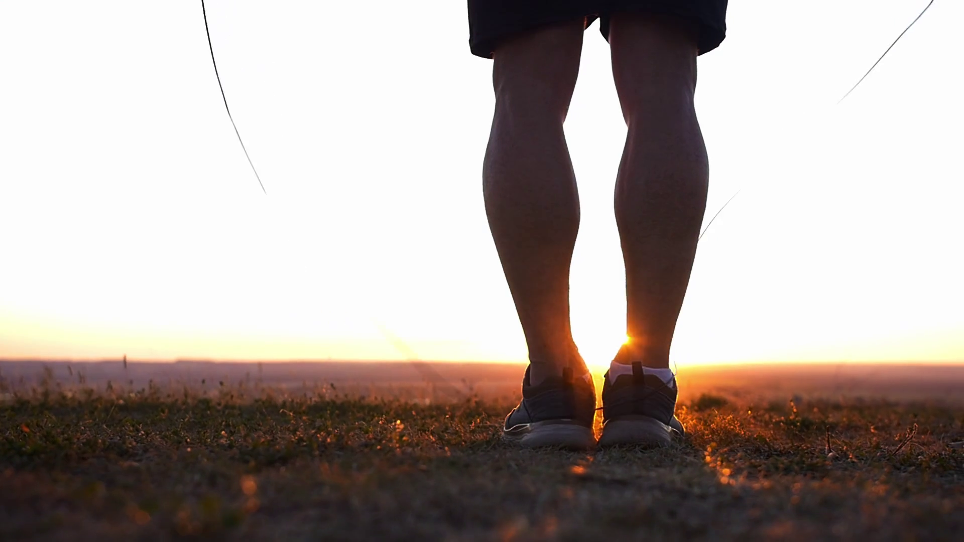 A muscular man jumping over the rope on the field at sunset Stock Video ...