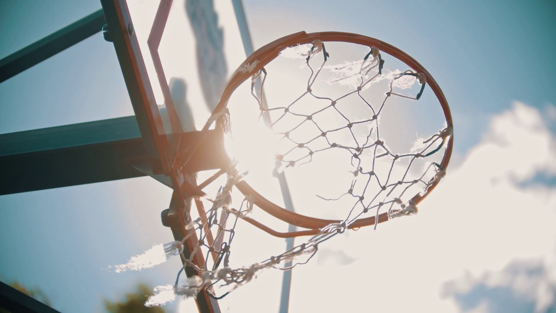 A basketball training outside. Throwing a ball in a basketball hoop