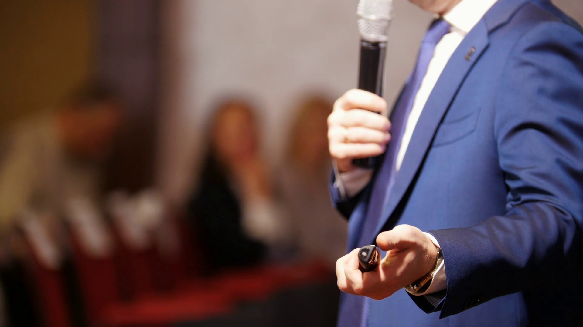 A Business Conference In The Hall A Man Talking On The Stage Using