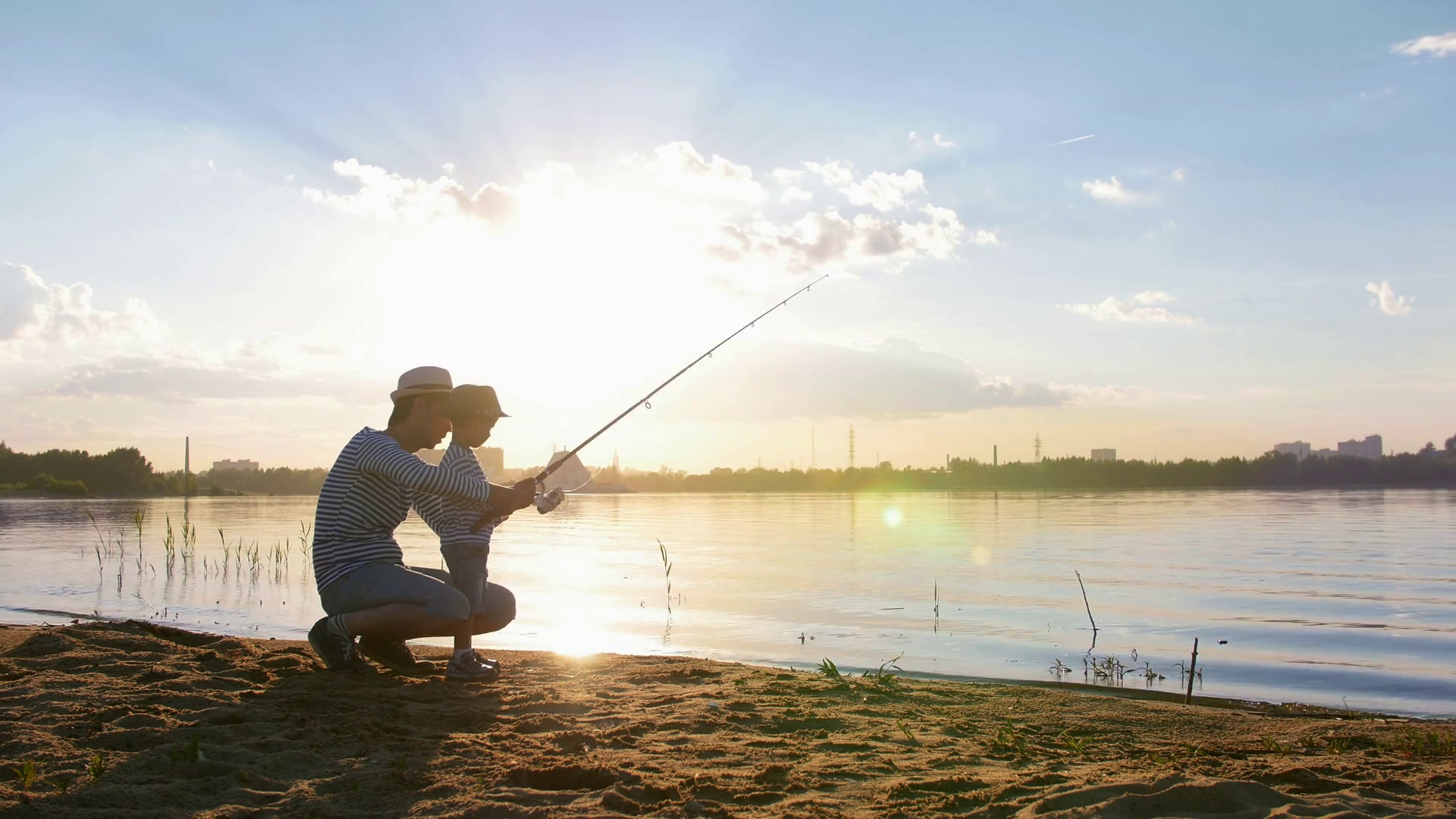 A father and his son on fishing a father sitting near