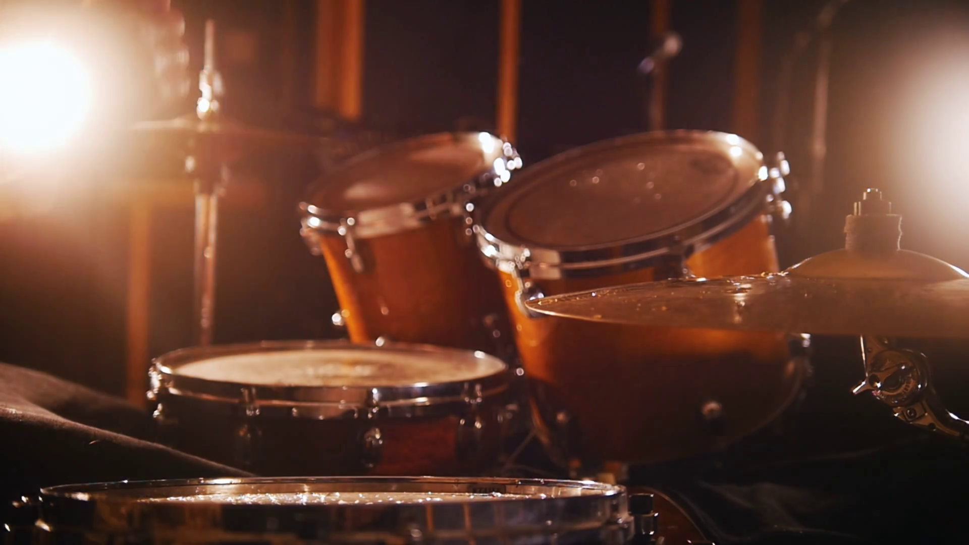 Drummer plays music on wet drums in studio in a garage. Stock Video