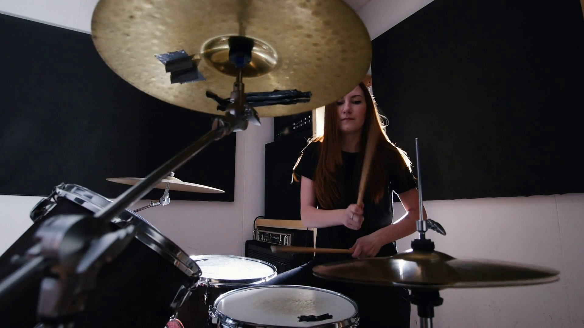 Girl is very emotional drummer plays the drums in the studio Stock