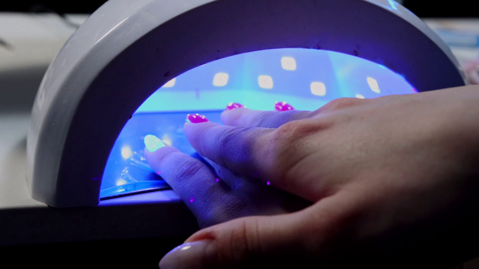 Hand of young woman in UV lamp gel polish manicure Stock Video Footage