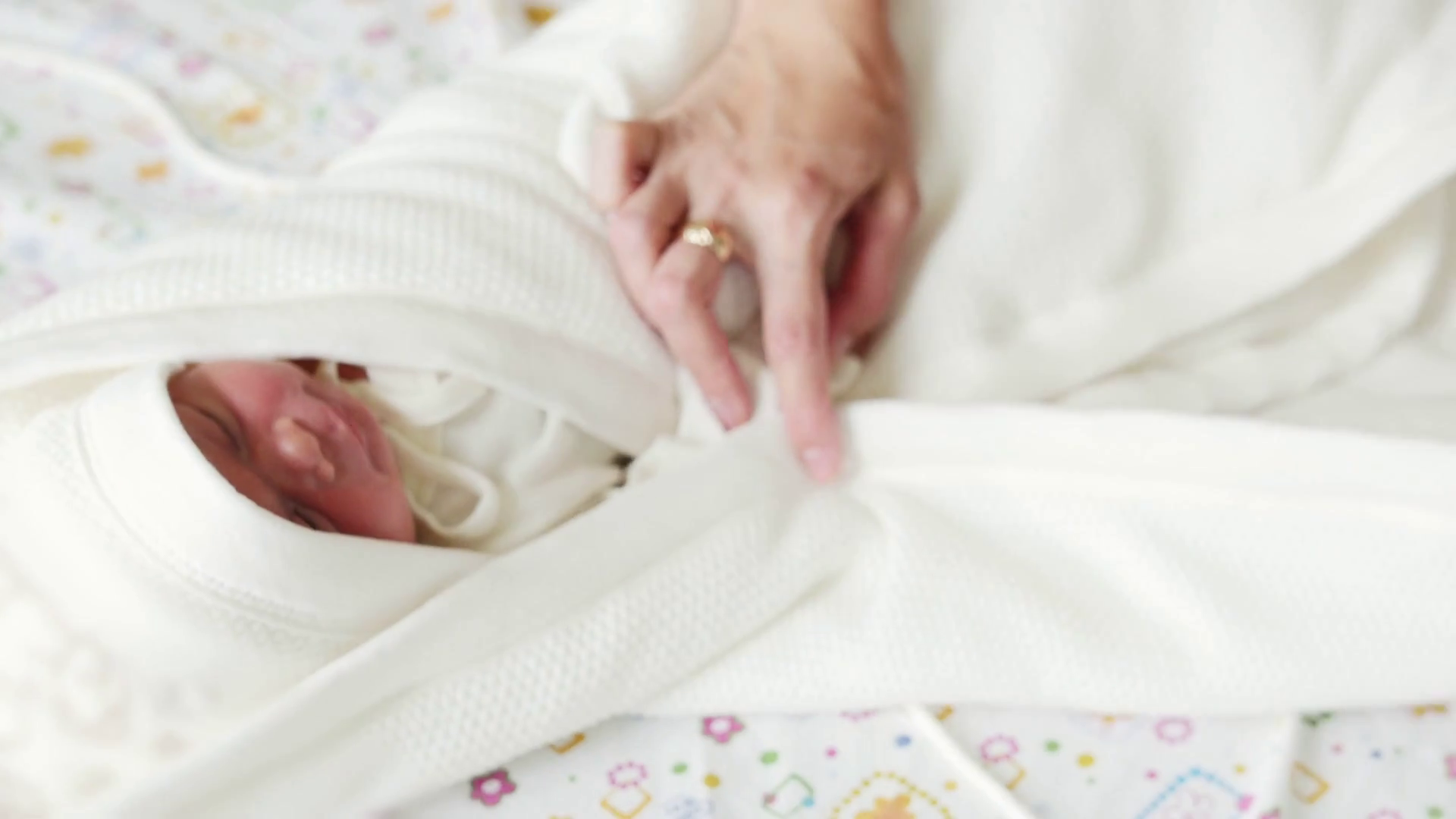 Maternity hospital mother is swaddling a newborn baby in the hospital