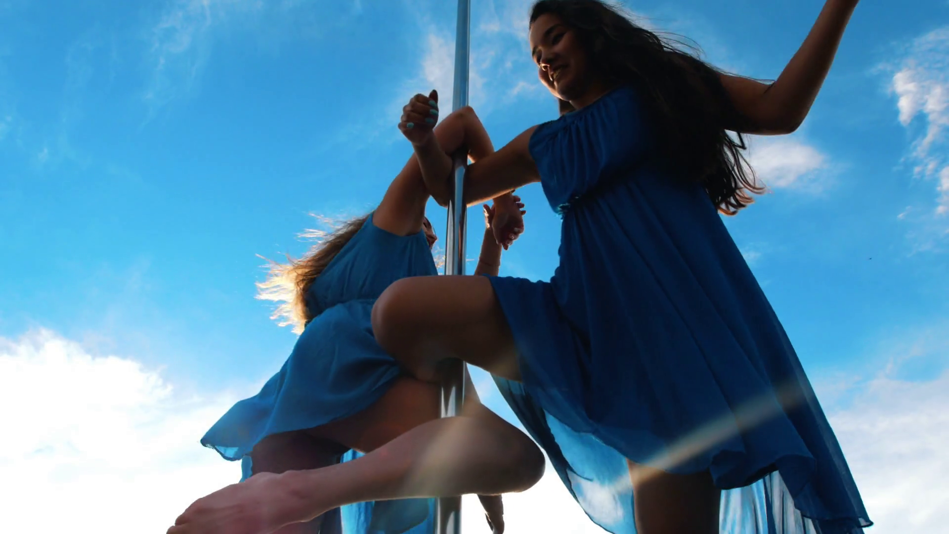 Two Female Poledancers In Blue Dresses Stock Footage SBV325084243