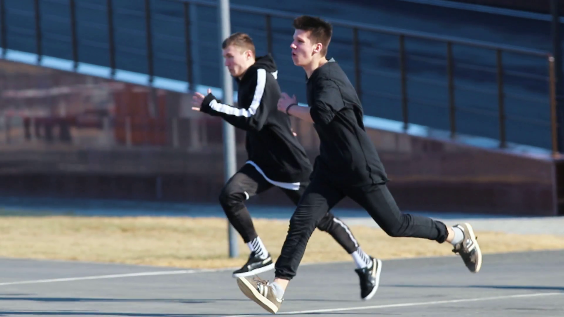 Two young men performing acrobatic parkour tricks. obstacles