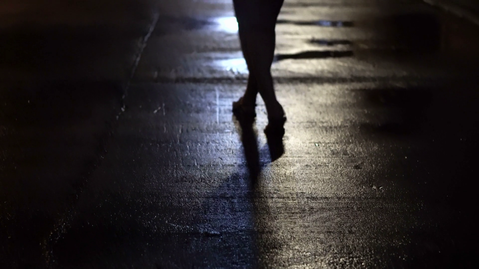 Woman walking alone in dark wet street at night abstract crime Stock Video Footage Storyblocks