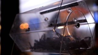 Close-up of the rotation of a transparent lottery reel with lottery tickets
